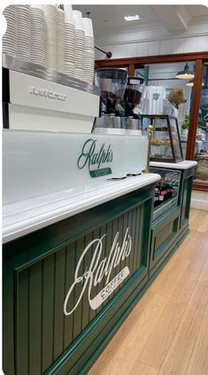 an image of a coffee shop counter that is green and white with the word belkin's on it