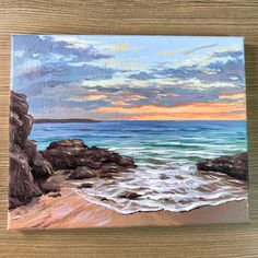 an acrylic painting of the beach at sunset with waves coming in from the ocean