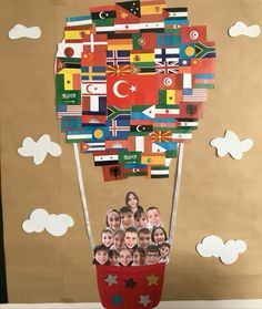 a hot air balloon made out of many different countries and flags is shown in front of a brown background