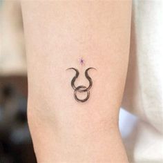 a tattoo on the leg of a woman with an omen symbol tattooed on it