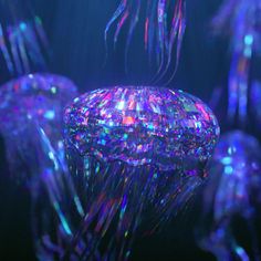 jellyfishs are floating in the water with colorful lights on them's body