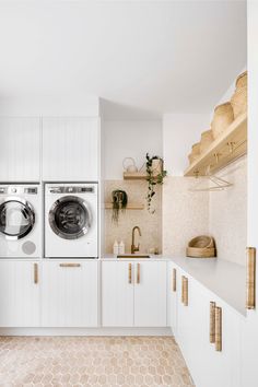 a washer and dryer in a white laundry room with honeycomb flooring