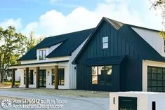 a large white and black house with lots of windows