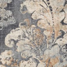 an old rug with flowers and leaves in grey, beige and white colors on it