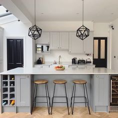 a kitchen with two stools and an island