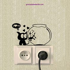 an electrical outlet with a wall sticker depicting a cat and fish in a bowl