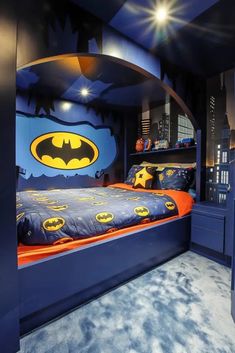 a batman themed bedroom with blue walls and carpeted flooring, built into the ceiling