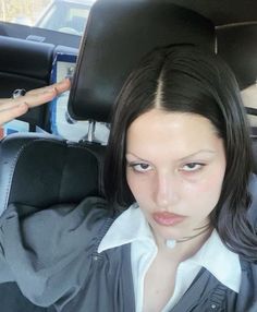 a woman sitting in the back seat of a car