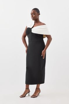 Experience Opulence In Our Plus Size Midi Dress, With A Fitted Silhouette, And An Asymmetric Strap Design, With One That Sits Off The Shoulder And One On The Shoulder. Style It With Strappy Heels For An Occasion Look That Will Take You From Wedding Guest Days To Party Nights. Plus Size Figure Form Bandage Knit Asymmetric Strap Midi Dress High Quality, Soft Knit Fabric Flattering Figure Hugging Fit Unique, Asymmetric Strap Detailing Thigh High Leg Split In Back Zip Fastening In Back Expertly Desi