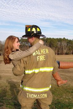 a man and woman dressed in firefighter gear