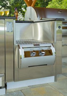 an outdoor kitchen with stainless steel appliances