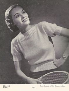 an old black and white photo of a woman holding a tennis racket