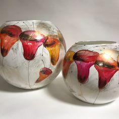 two vases with flowers painted on them