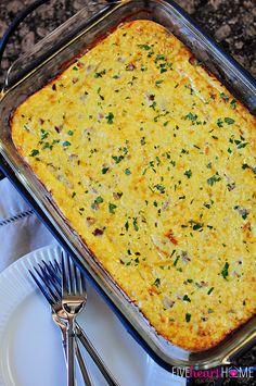 a casserole dish is on a plate with silverware