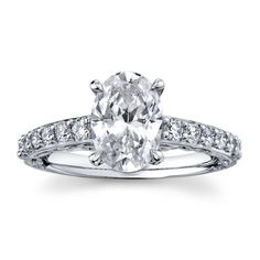 an oval cut diamond engagement ring with pave set diamonds on the shoulders and sides