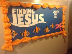 a sign that says finding jesus under the sea is hanging on a wall in a room