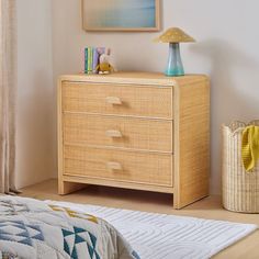 a bedroom scene with focus on the dresser and bed side table in the foreground