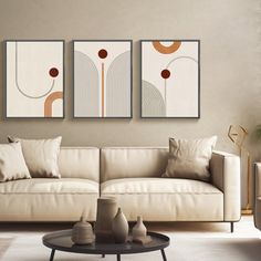 a living room with three paintings on the wall