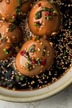 some kind of food in a bowl with sesame seeds and other toppings on top