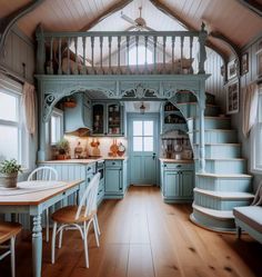 a kitchen with blue cabinets and wooden floors is shown in this image, the stairs lead up to the second floor