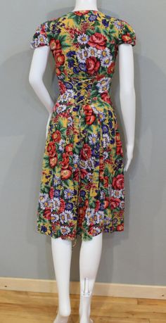 "Good condition, 90's floral button up dress. In Charge brand. 100% rayon. Made in India. Vintage tag size small. Many colors on dress; pink, red, white, cornflower blue, hunter green, light green, yellow, purple, navy blue. Measurements: Chest:31\" Waist (corset type adjustments): At smallest: 22\" At largest: 29\" Hips:50\" Sleeve:8 1/2\" (from bottom collar seam to cuff) Length:42 1/2\" BEFORE YOU BUY, PLEASE USE THE LISTED MEASUREMENTS TO CHECK FOR FIT: Pick a garment that fits you well ( si White Cornflower, Yellow Corset, Vintage Levi Shorts, Waist Corset, Gunne Sax Dress, Western Jeans, Corset Back, Floral Button Up, Button Up Dress