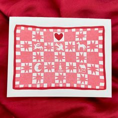 a piece of paper that has some type of pattern on it and is red with white squares