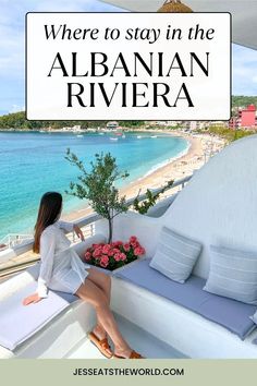 a woman sitting on top of a balcony next to the ocean with text overlay reading where to stay in the alban riviera