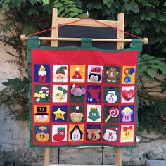 a wooden easel with a christmas themed quilt on it