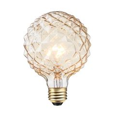 a light bulb that is on top of a white wall mounted fixture with an intricate design