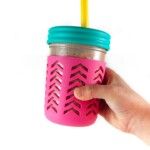 a hand holding a pink cup with a yellow straw in it and a blue lid