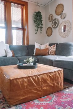 a living room filled with furniture and lots of pillows on top of the couches