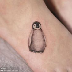 a small penguin tattoo on the ankle