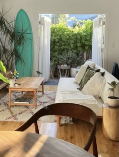 a living room filled with furniture and plants