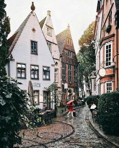 a cobblestone street lined with tall buildings