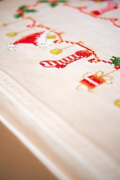 a close up of a cross - stitch pattern on a table cloth