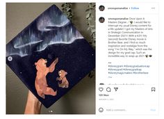 someone is holding up a graduation cap with the image of two bears dancing in front of an aurora bore