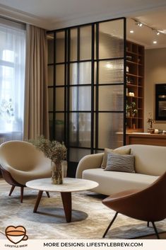 a living room with two chairs and a coffee table in front of a large window