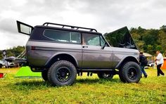 an off road vehicle parked in the grass