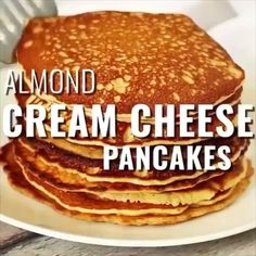 a stack of pancakes sitting on top of a white plate with the words almond cream cheese pancakes