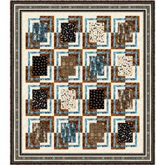 a quilt made with squares and designs on the front, in blue, brown and white