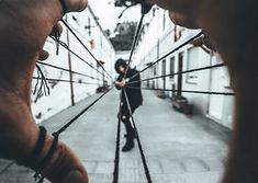 two people standing in an alley with their hands on the spokes