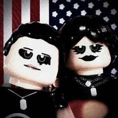 two legos are standing next to each other in front of an american flag