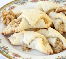 several pastries on a white plate with flowers