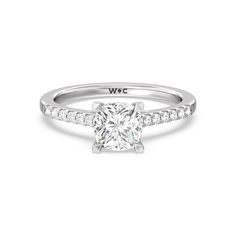 a diamond engagement ring with channel set shoulders