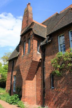 an old brick building with stairs leading up to the roof and windows on each side