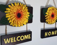 two sunflowers are hanging on the wall next to each other with welcome home signs