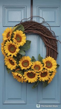 a wreath with sunflowers hanging on the front door