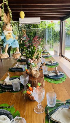 a long table set with place settings and plates for easter bunny themed tablescapes