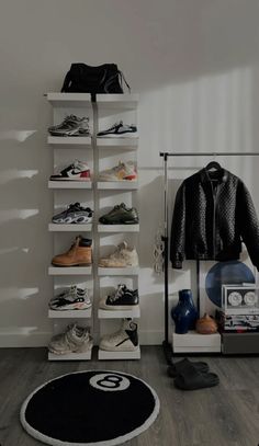 a room filled with lots of shoes and sneakers on shelves next to a wall mounted speaker