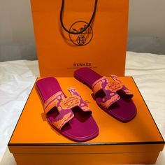 Hermes Sandal In Cotton Canvas Strap Size 34 1/2 With "Brides De Gala" Print And Iconic "H" Cut-Out. Orange & Pink Mutlicolor Final Sale, No Returns. An Iconic Hermes Style, This Silhouette Is An Essential Piece In Every Wardrobe. Made In Italy. Comes With Hermes Box, 2 Dust Bag, And Receipt. Fuschia Goatskin Insole And Lining Fuschia Leather Sole Leather Heel Designer Multicolor Beach Sandals, Designer Flat Slides For Beach, Designer Multicolor Flat Sandals, Designer Multicolor Sandals For Vacation, Luxury Orange Sandals With Removable Insole, Luxury Pink Sandals For Vacation, Luxury Pink Sandals For The Beach, Hermes Sandal, Hermes Limited Edition